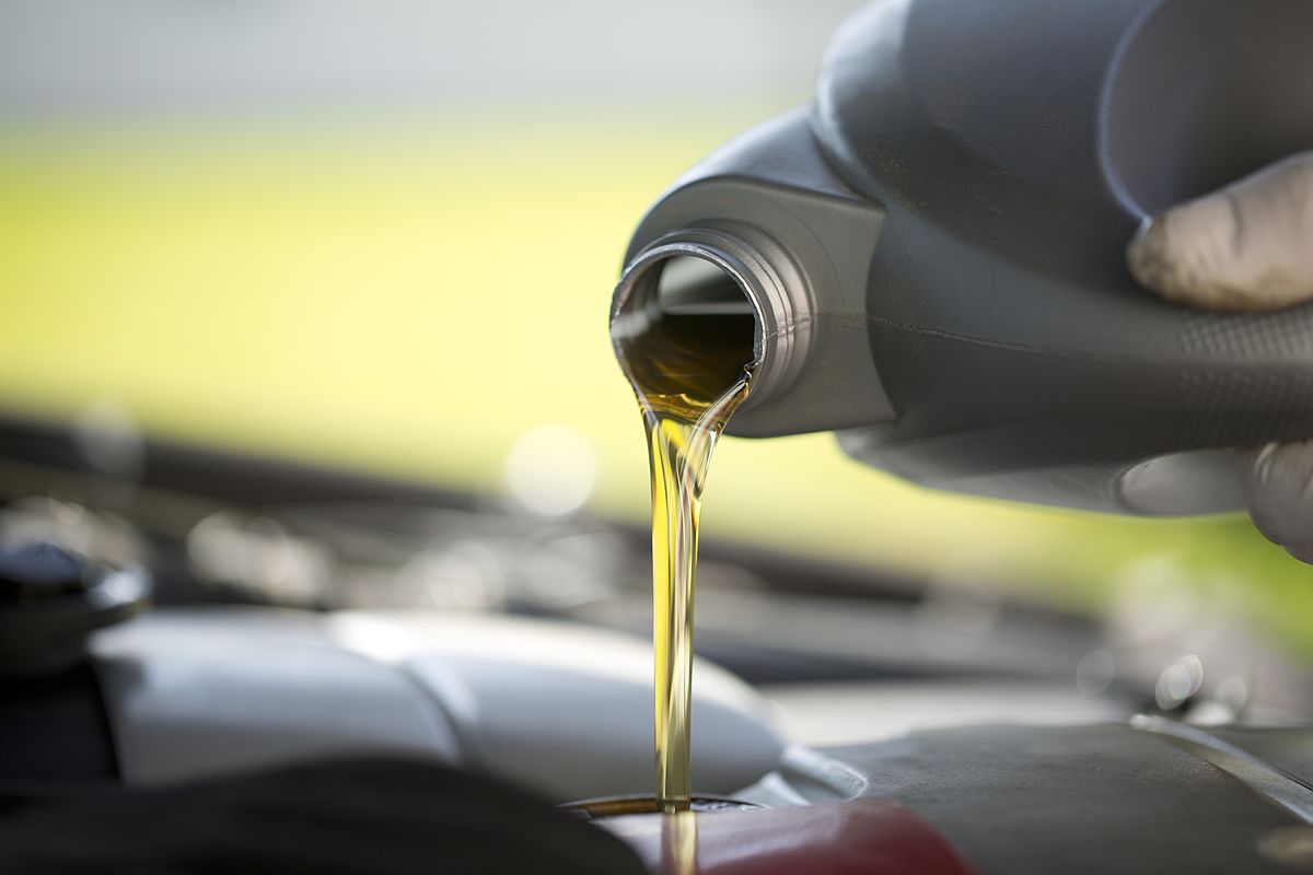 a close up of a car engine oil pouring